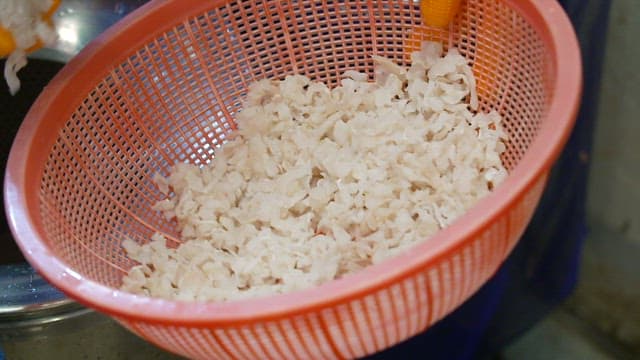 Rinsing chopped ingredients in a colander