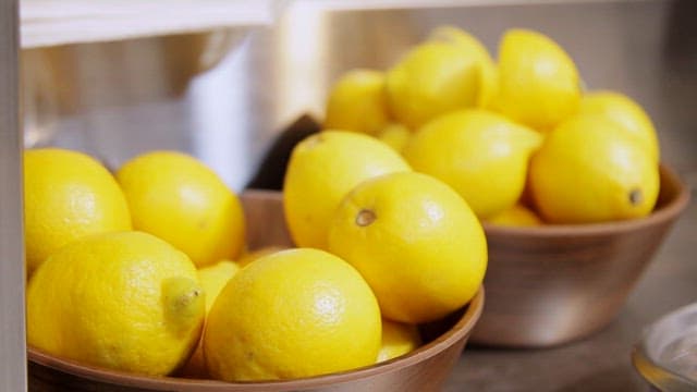 Fresh lemons in wooden bowls