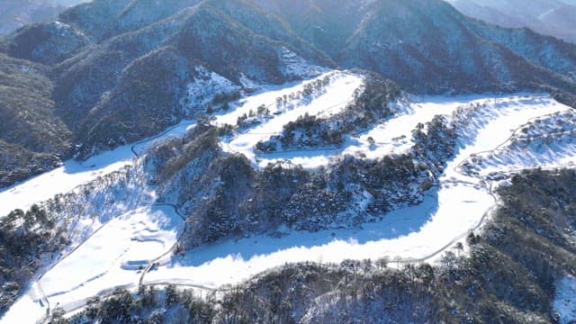 Snow-covered mountains and winding roads