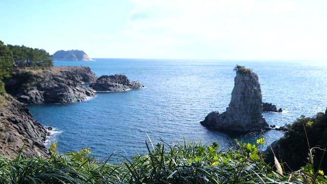 Sea under a sunny sky with high rocks