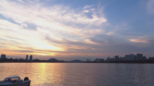 Sunset over a city skyline by the river