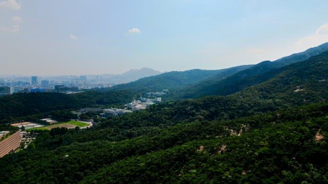 Green mountain with city view