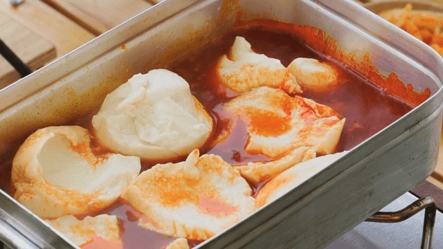 Soft tofu stew cooked in a portable metal pot