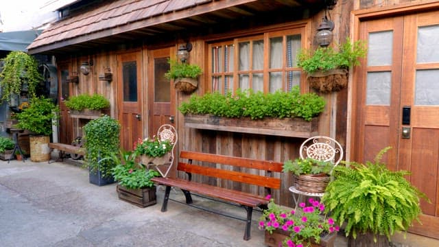 Quaint wooden building with lush plants