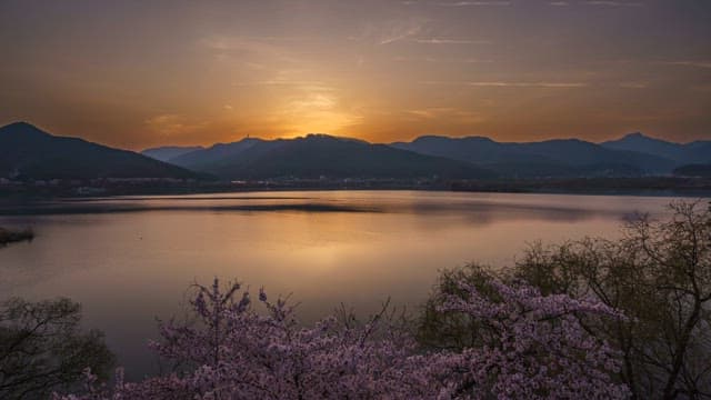 Sunrise over a tranquil lake with mountains