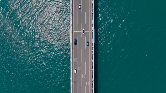 Gwangan Bridge over the blue sea leading to the city skyline of Busan