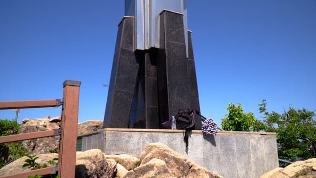 Mountain landscape with a tower commemorating the summit