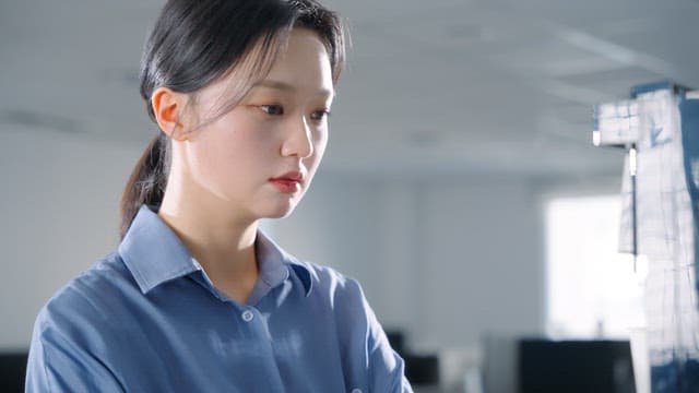 Woman using a coffee machine in an office