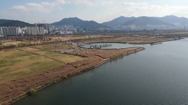Cityscape with a marina and mountains