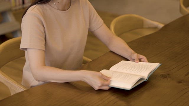 Woman Reading a Book in a Quiet Space