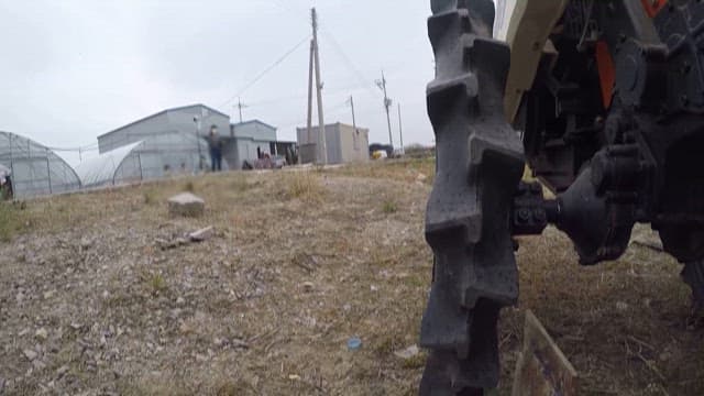 Tractor Wheels Rolling on Rural Farmland