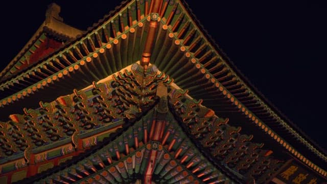 Geunjeongjeon Hall of Gyeongbokgung Palace lit up under the moonlight of a dark night