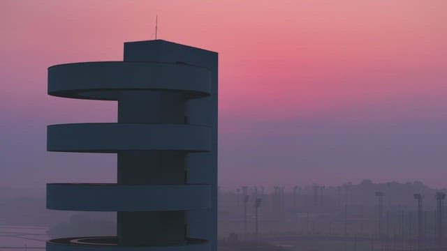 Modern tower against a pink sunset sky
