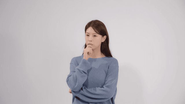 Woman lost in thought, resting her finger on her chin