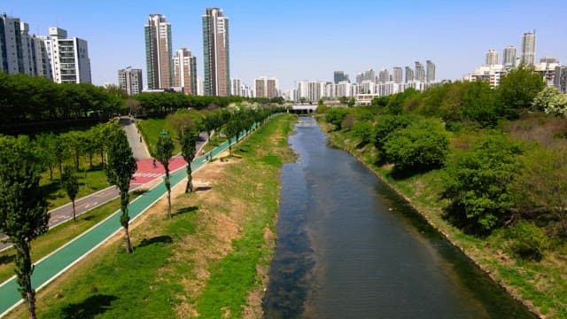 Downtown stream with walking paths and high-rise buildings