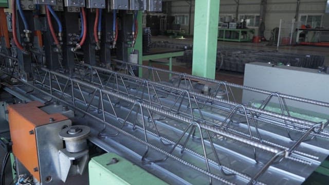 Metal rods being processed in a factory