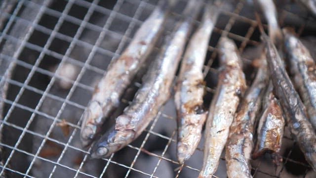 Anchovies being cooked on the grill