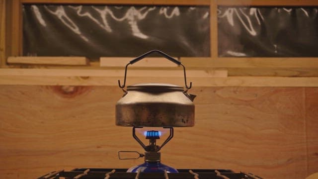 Kettle boiling on a gas stove indoors