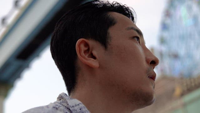 Man drinking water while looking around