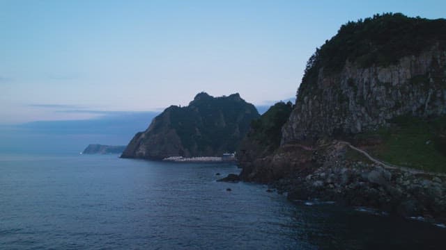 Coastal cliffs and calm sea at dawn