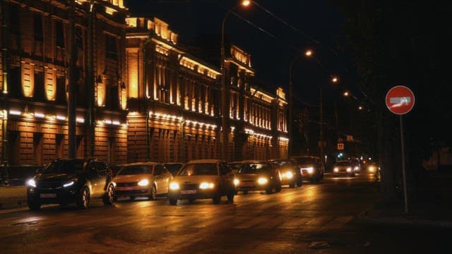 Illuminated magnificent building at night with street lamps