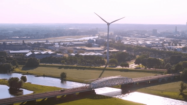 Wind turbine near a river and bridge