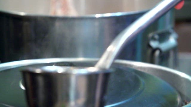 Steaming broth made by boiling pork bones and skulls