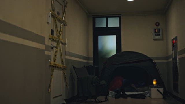 Tent set up in a dimly lit indoor hallway