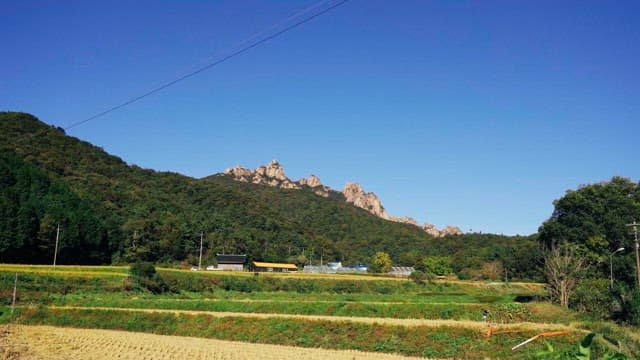 Rocky mountain in an agricultural village under clear skies