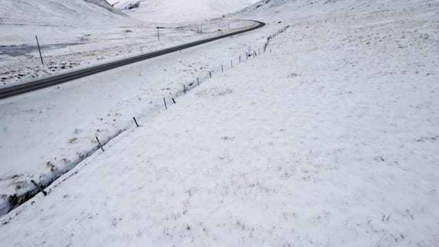 Snowy mountains and road with cars