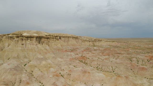 Expansive Badlands Under Overcast Skies