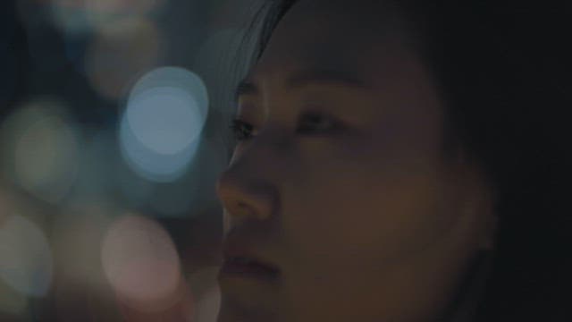 Contemplative Woman Amidst City Lights