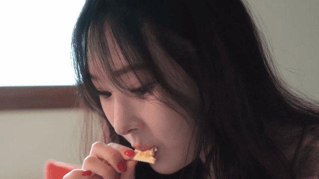 Woman enjoying a snack indoors