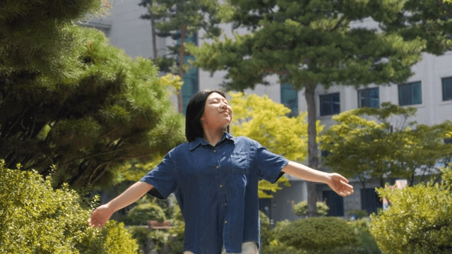 Woman enjoying a walk in a sunny garden