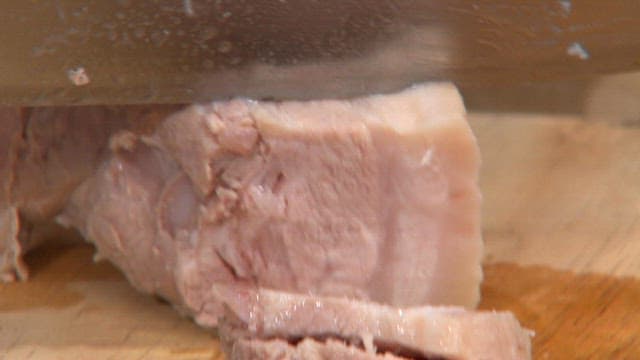 Chef Slicing Meat on a Cutting Board