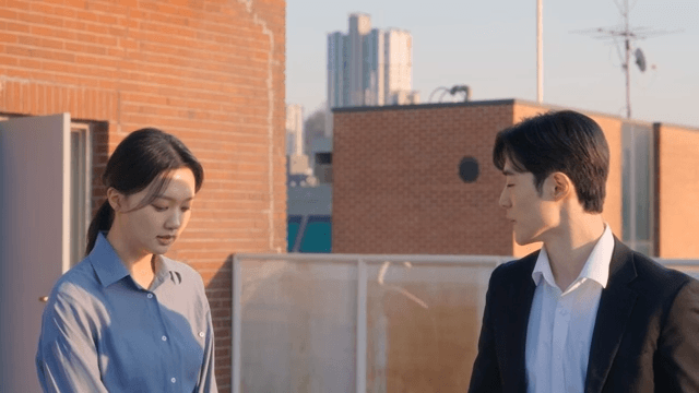 Two people conversing on a rooftop