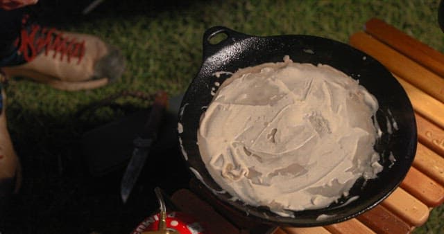 Preparing Vegetable Pancakes Outdoors at Night during Camping
