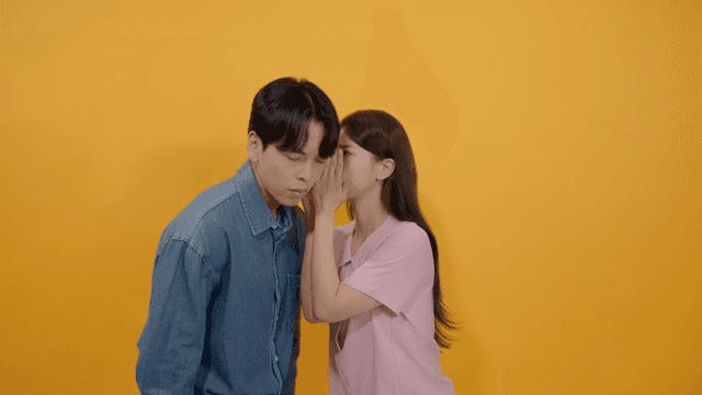 Man and a woman whispering quietly with serious faces