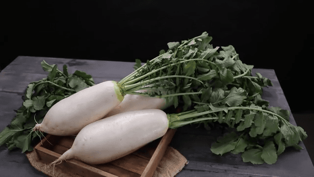 Fresh radishes on a wooden table
