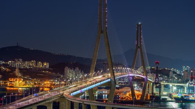 Colorful illuminated Busanhangdaegyo Bridge at night with cityscape