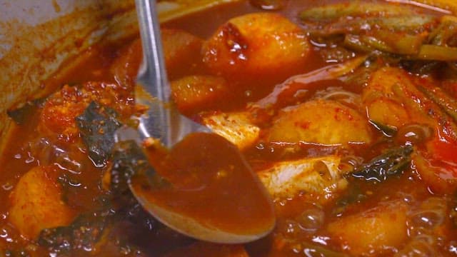 Braised fish and radish boiling in a pot