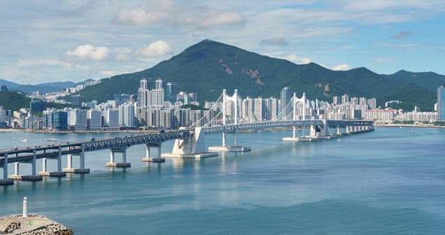 Gwangan Bridge and buildings in Busan crossing the sea under a clear sky