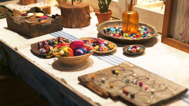 Handcrafted colorful accessories displayed on a table at a market
