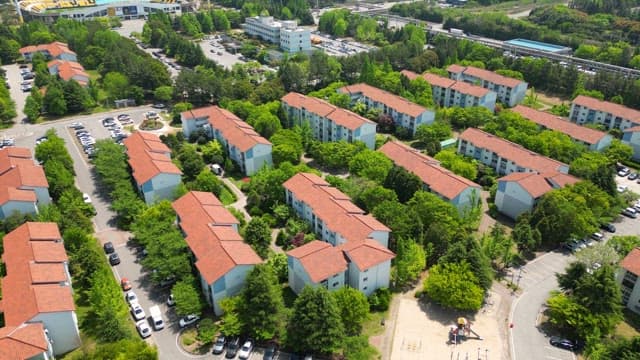 Residential Area with Orange Roofs Surrounded by Trees
