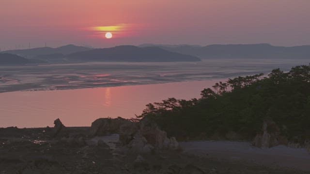 Sunset over a tranquil coastal landscape
