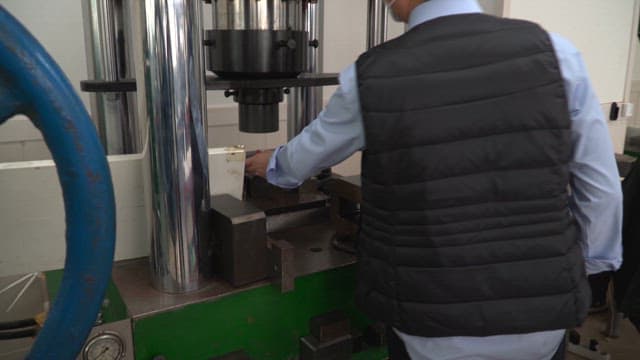 Worker operating a machine in a factory