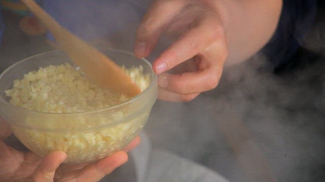 Frying the minced garlic in a frying pan