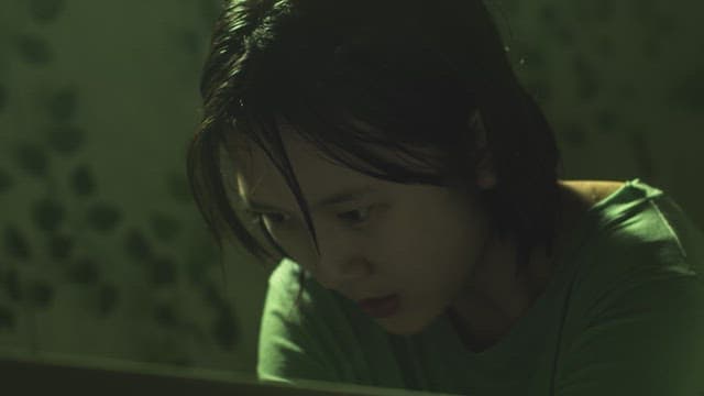 Girl out of breath in front of a mirror in a dark room