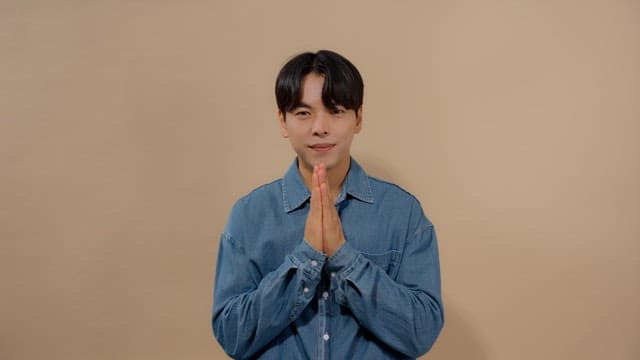 Man with his hands together, showing respect and gratitude