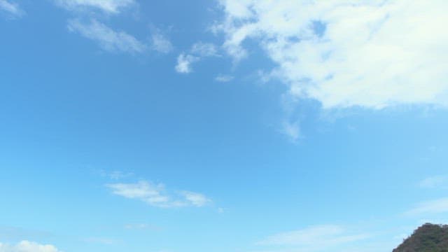 Peaceful coastal town with mountains and blue sky